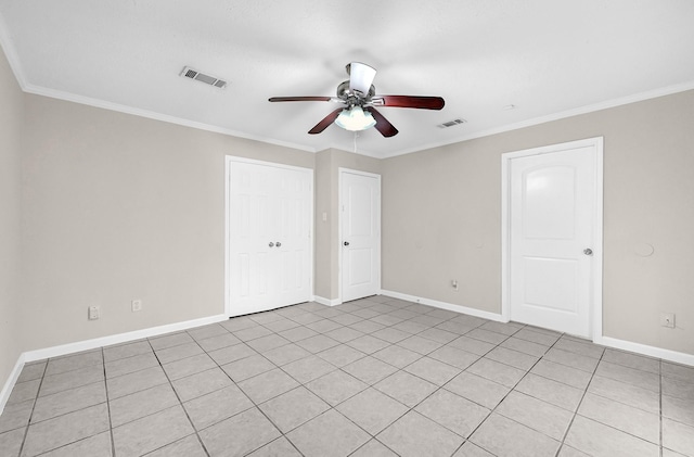 unfurnished bedroom with ceiling fan, baseboards, crown molding, and visible vents