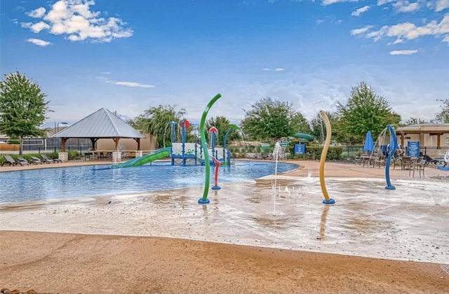 exterior space with a gazebo, a water play area, and fence