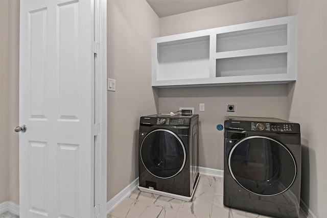 laundry area with laundry area, marble finish floor, baseboards, and washing machine and clothes dryer