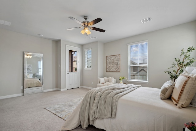 bedroom with light colored carpet, baseboards, visible vents, and multiple windows