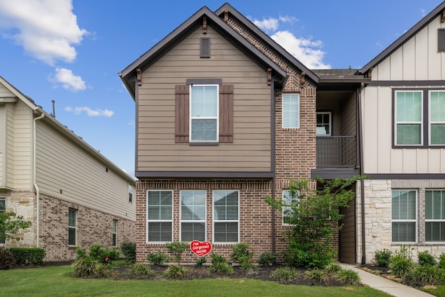 view of front facade with board and batten siding and brick siding