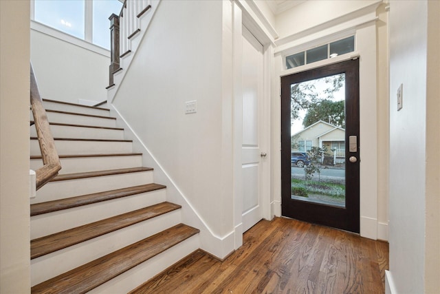entryway featuring wood finished floors and stairs
