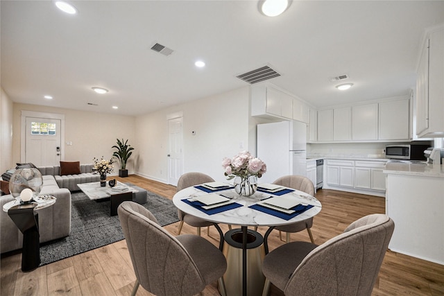 dining area featuring light wood-style floors, visible vents, and recessed lighting