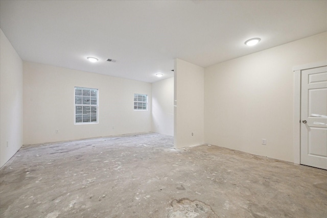 unfurnished room featuring visible vents