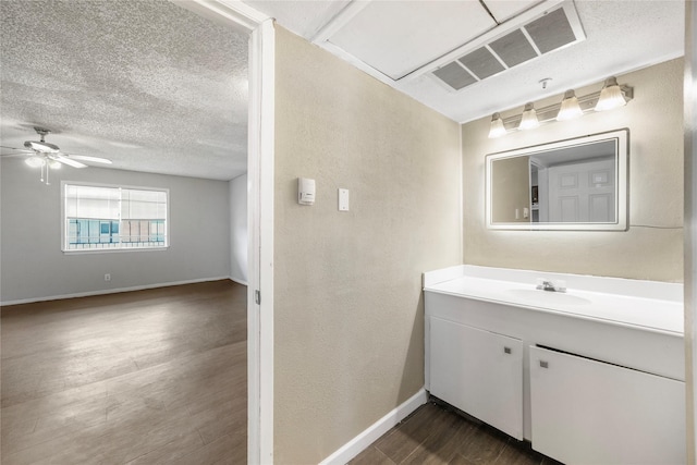 6231 Westward St Unit 20, Houston, TX 77081 - bathroom with a textured ceiling, ceiling fan, visible vents, wood finished floors, and vanity