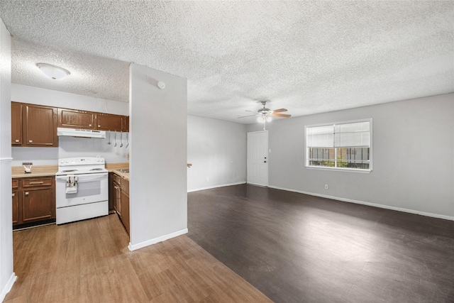 6231 Westward St Unit 20, Houston, TX 77081 - kitchen with wood finished floors, ceiling fan, electric range, and under cabinet range hood