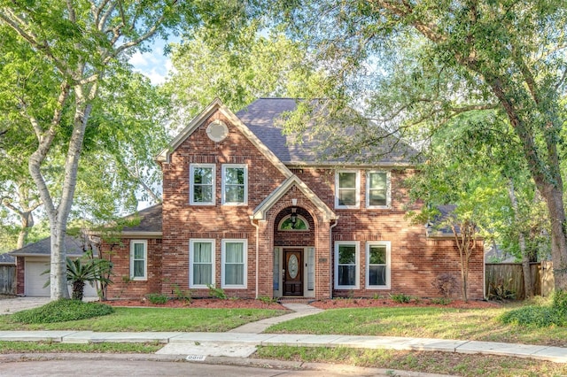 6619 Berrytree Ln, Sugar Land, TX 77479 - view of front of property with brick siding, fence, a shingled roof, and a front yard
