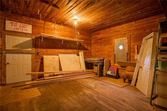 basement with wood walls, hardwood / wood-style flooring, and wood ceiling