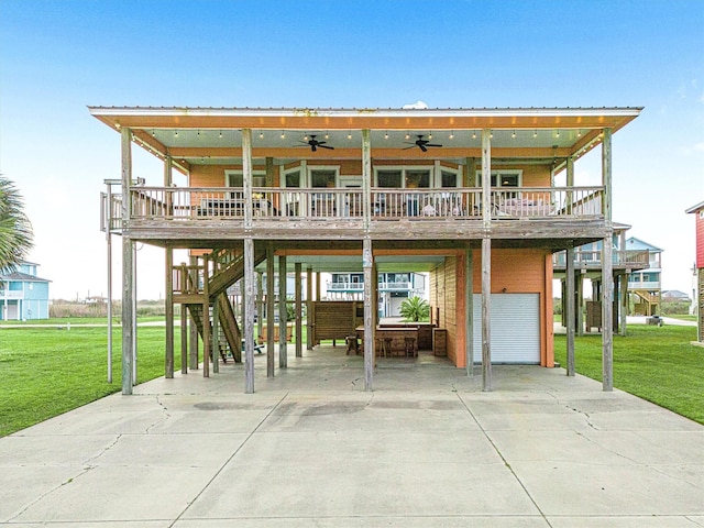 exterior space featuring concrete driveway, a carport, ceiling fan, and a front yard