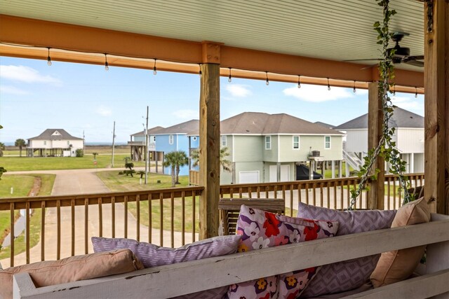 wooden terrace with a residential view and an outdoor hangout area