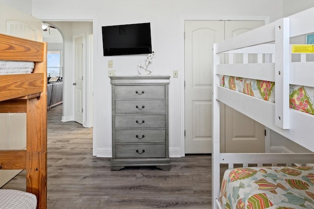 bedroom featuring baseboards and wood finished floors