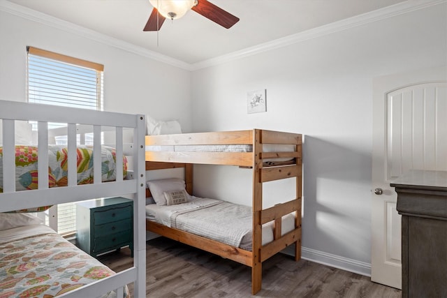 bedroom featuring ceiling fan, baseboards, ornamental molding, and wood finished floors