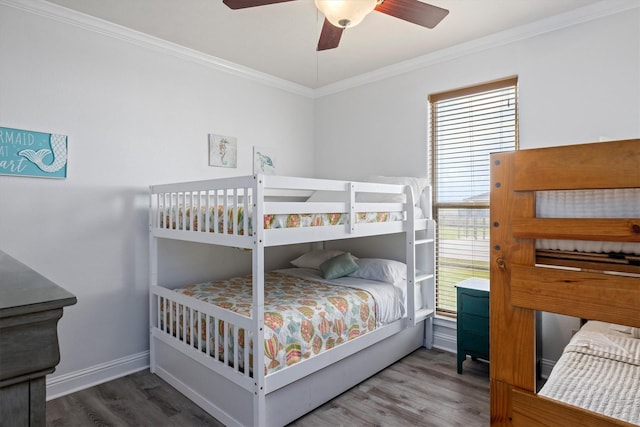 bedroom featuring baseboards, a ceiling fan, wood finished floors, and crown molding