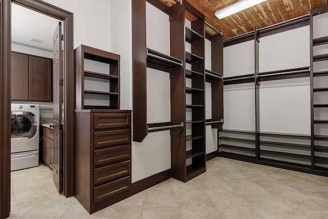spacious closet featuring washer / dryer, light tile patterned floors, and visible vents