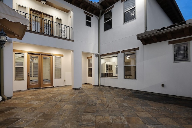 rear view of property featuring stucco siding and a patio area
