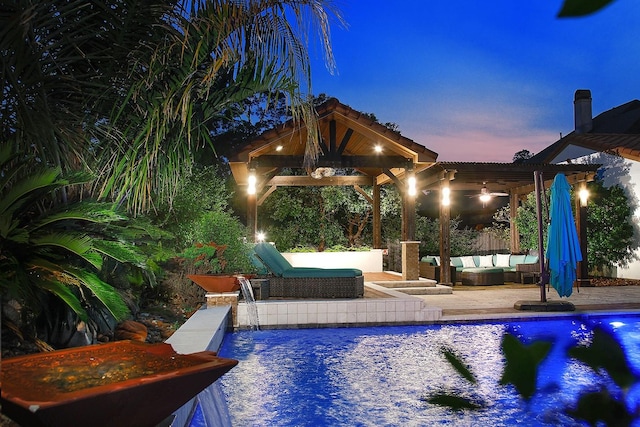 pool featuring a gazebo, a patio area, and an outdoor hangout area