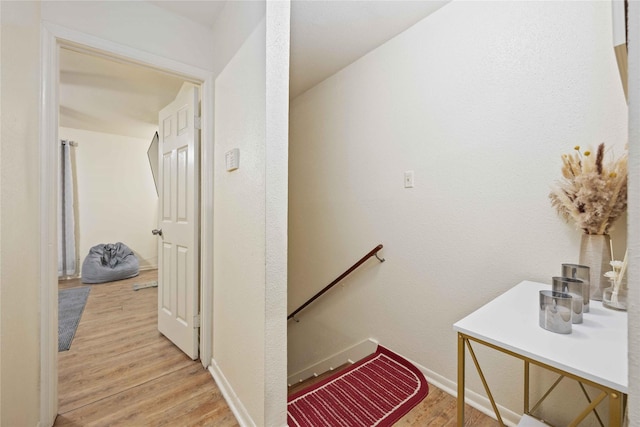 stairs featuring wood finished floors and baseboards