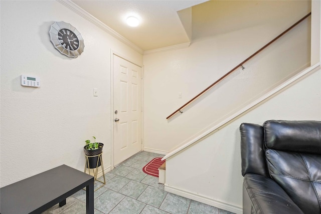 entrance foyer with light tile patterned floors, ornamental molding, and stairs