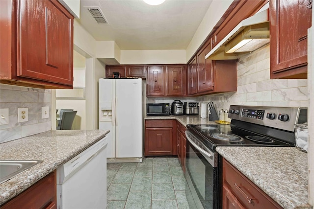 kitchen with tasteful backsplash, white appliances, a sink, visible vents, and light tile patterned flooring