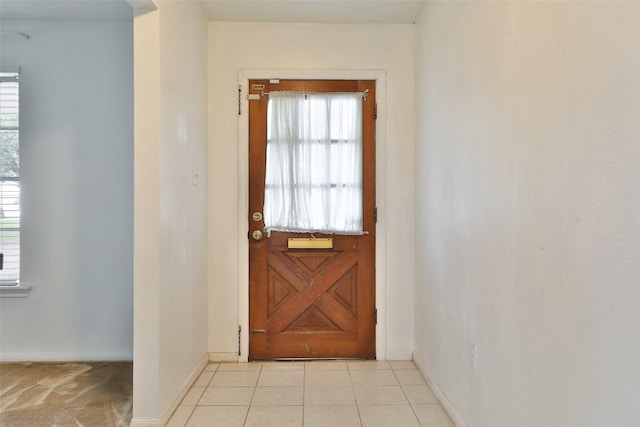 doorway featuring baseboards