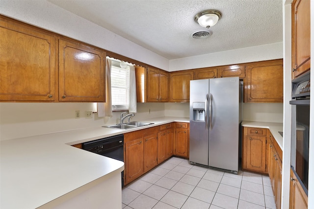 kitchen with brown cabinets, light countertops, stainless steel refrigerator with ice dispenser, and a sink