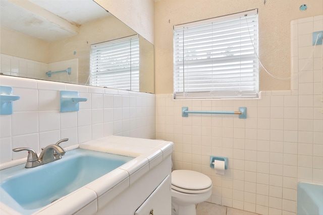 full bath with tile walls, plenty of natural light, and toilet