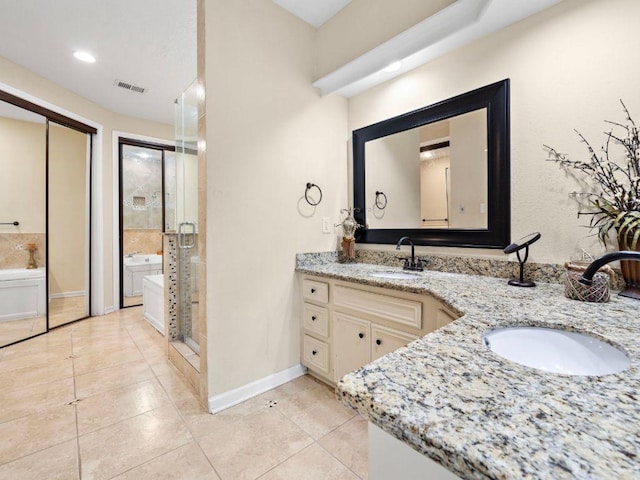 6729 Tournament Dr, Houston, TX 77069 - full bathroom with double vanity, a stall shower, a bath, tile patterned floors, and recessed lighting