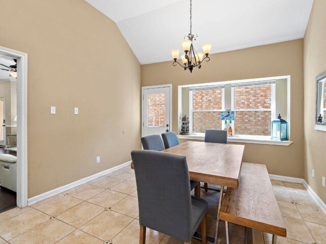 6729 Tournament Dr, Houston, TX 77069 - dining room featuring light tile patterned floors, vaulted ceiling, and a chandelier