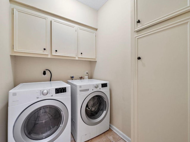 6729 Tournament Dr, Houston, TX 77069 - washroom with cabinet space, washing machine and dryer, and light tile patterned floors