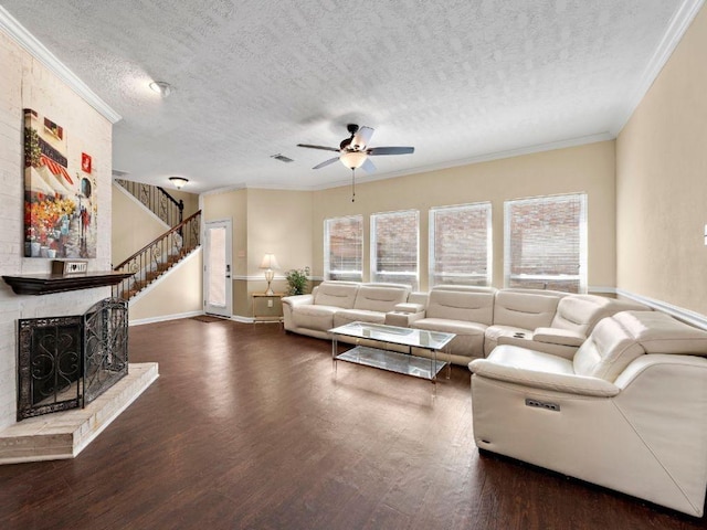 6729 Tournament Dr, Houston, TX 77069 - living area featuring a textured ceiling, a ceiling fan, wood finished floors, crown molding, and a fireplace