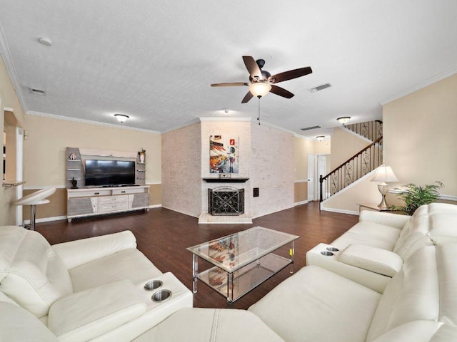 6729 Tournament Dr, Houston, TX 77069 - living area with stairs, a ceiling fan, wood finished floors, crown molding, and a large fireplace