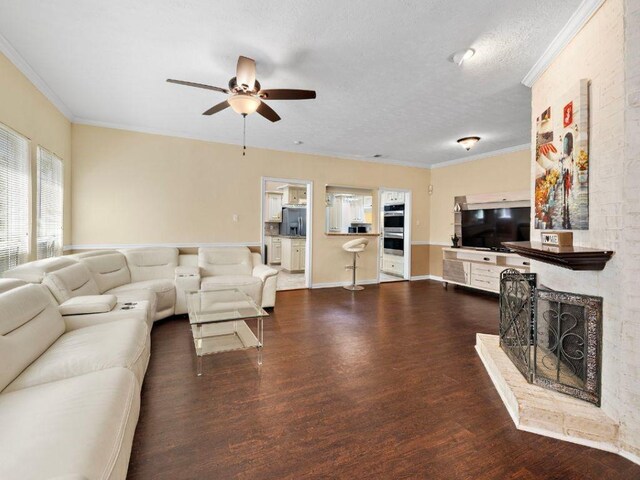 6729 Tournament Dr, Houston, TX 77069 - living area featuring dark wood finished floors, a ceiling fan, a textured ceiling, ornamental molding, and a large fireplace