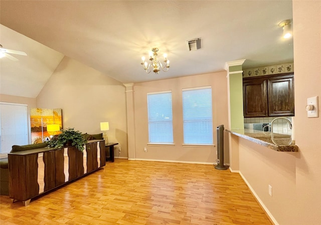 dining area featuring visible vents, baseboards, light wood-style flooring, and ceiling fan with notable chandelier