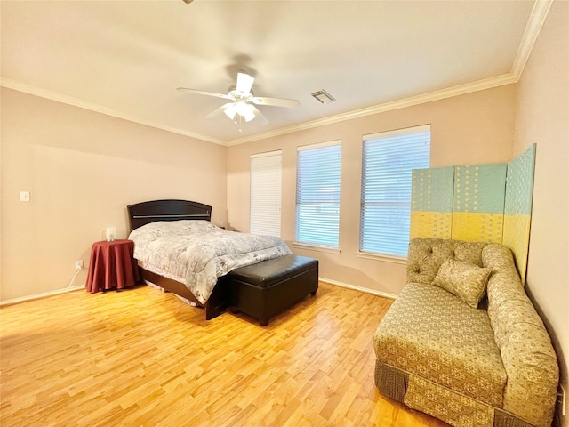 bedroom featuring visible vents, ceiling fan, baseboards, ornamental molding, and wood finished floors