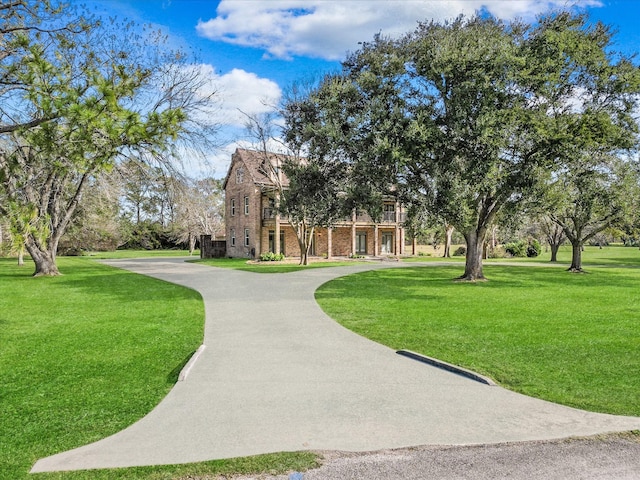 3003 Sky Ranch Dr, Alvin, TX 77511 - view of community featuring a yard and curved driveway