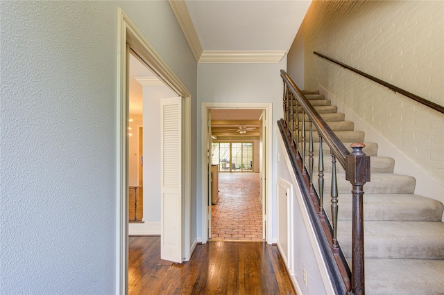 7530 Del Monte Dr, Houston, TX 77063 - stairs with crown molding, baseboards, a textured wall, and wood finished floors