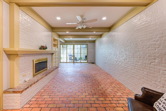 7530 Del Monte Dr, Houston, TX 77063 - unfurnished living room featuring beam ceiling, brick wall, a fireplace, brick floor, and a ceiling fan