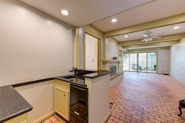 7530 Del Monte Dr, Houston, TX 77063 - kitchen with a ceiling fan, a brick fireplace, a sink, open floor plan, and brick floor