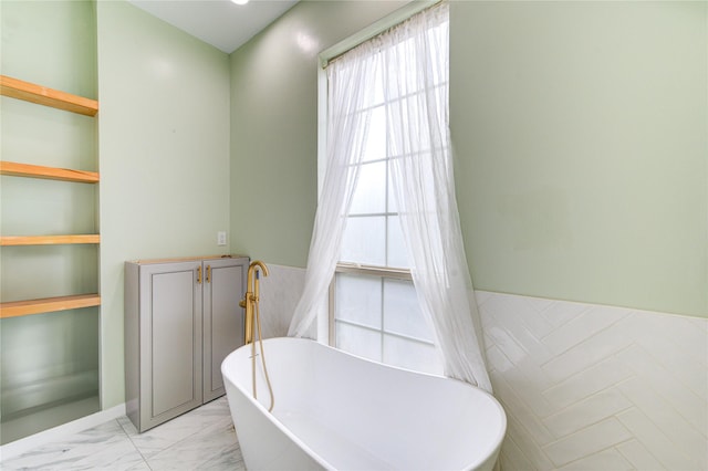 7530 Del Monte Dr, Houston, TX 77063 - full bathroom with a freestanding bath, wainscoting, and marble finish floor