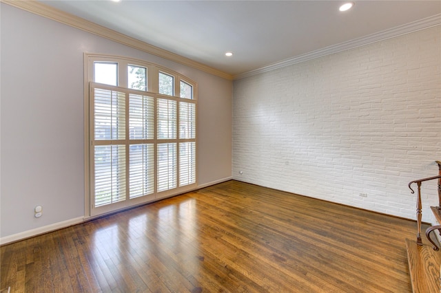 7530 Del Monte Dr, Houston, TX 77063 - spare room with wood-type flooring, brick wall, recessed lighting, baseboards, and ornamental molding