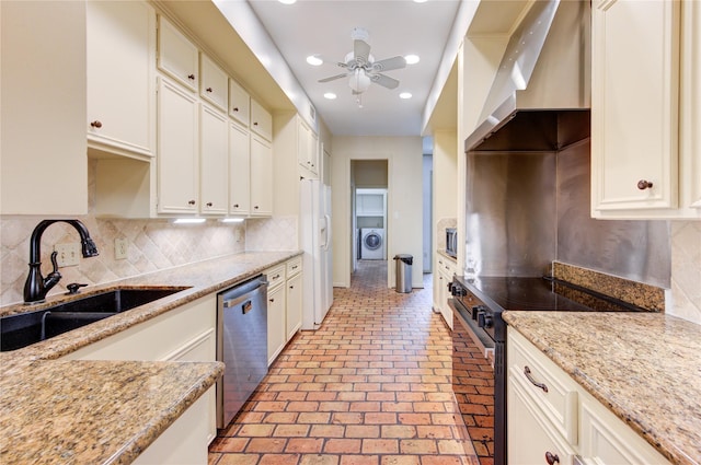 7530 Del Monte Dr, Houston, TX 77063 - kitchen with wall chimney range hood, brick floor, tasteful backsplash, a sink, and stainless steel appliances