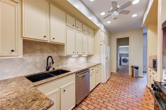 7530 Del Monte Dr, Houston, TX 77063 - kitchen with ceiling fan, a sink, stainless steel appliances, decorative backsplash, and washing machine and dryer