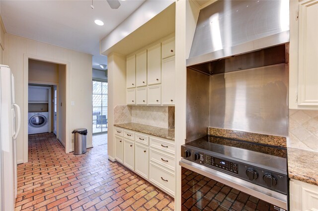 7530 Del Monte Dr, Houston, TX 77063 - kitchen featuring white refrigerator with ice dispenser, electric stove, washer / dryer, brick floor, and wall chimney exhaust hood