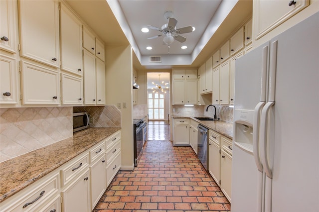 7530 Del Monte Dr, Houston, TX 77063 - kitchen featuring visible vents, appliances with stainless steel finishes, a sink, ceiling fan with notable chandelier, and recessed lighting