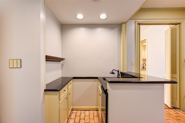 7530 Del Monte Dr, Houston, TX 77063 - kitchen with a peninsula, brick floor, a sink, dark stone countertops, and dishwasher