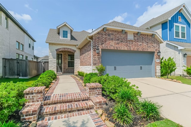 19622 Upper Canyon Ct, Cypress, TX 77433 - view of front of house featuring a shingled roof, brick siding, concrete driveway, an attached garage, and fence