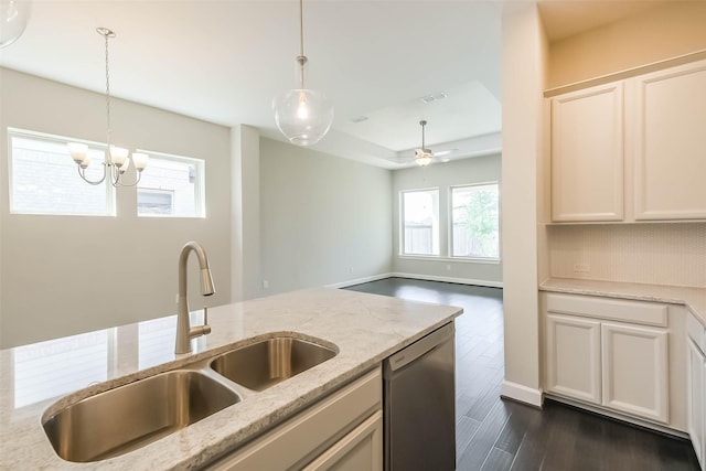 19622 Upper Canyon Ct, Cypress, TX 77433 - kitchen with dark wood finished floors, light stone counters, dishwasher, a sink, and pendant lighting