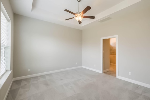 19622 Upper Canyon Ct, Cypress, TX 77433 - empty room featuring visible vents, ceiling fan, a tray ceiling, baseboards, and carpet