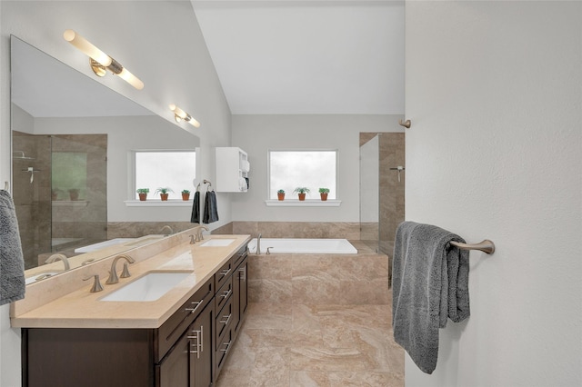 bathroom featuring a garden tub, a sink, a tile shower, and double vanity
