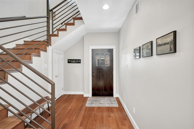 5733 Petty St, Houston, TX 77007 - foyer entrance with wood finished floors, stairway, baseboards, and recessed lighting